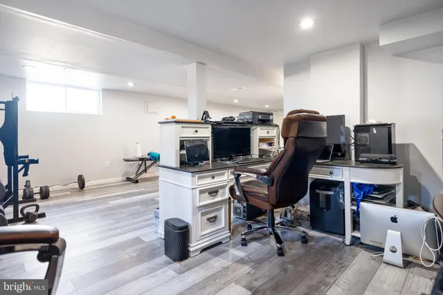 a view of a workspace with furniture and wooden floor