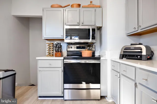 a kitchen with a stove and a microwave