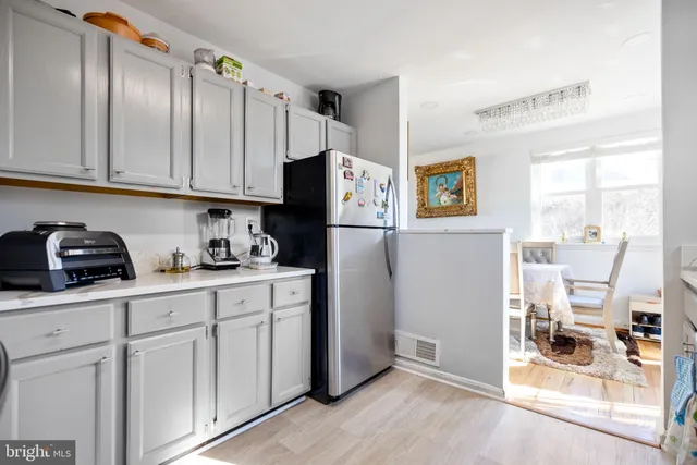 a kitchen with cabinets and a window