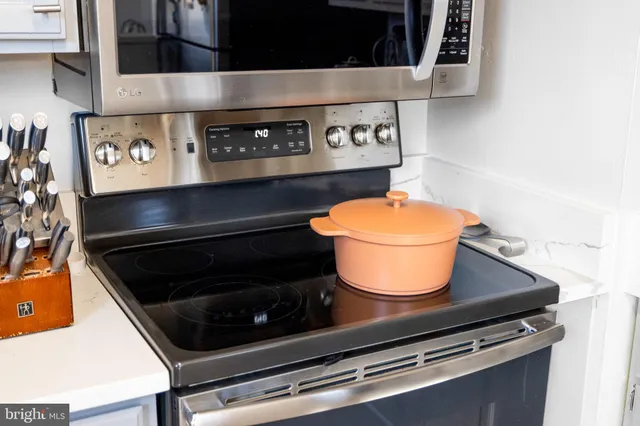 a stove top oven sitting inside of a kitchen