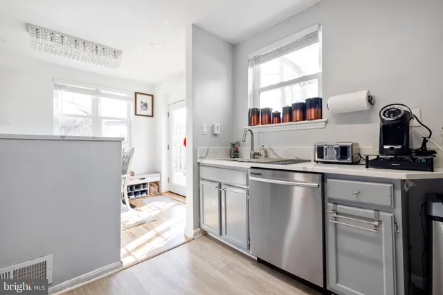 a kitchen with stainless steel appliances granite countertop a refrigerator and a stove