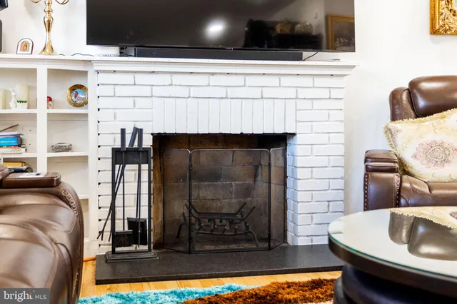 a front view of a house with a yard covered with snow and trees