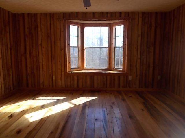 8119 Primm Springs Road Lyles, TN 37098 - Photo 6 of 12 an empty room with wooden floor and windows
