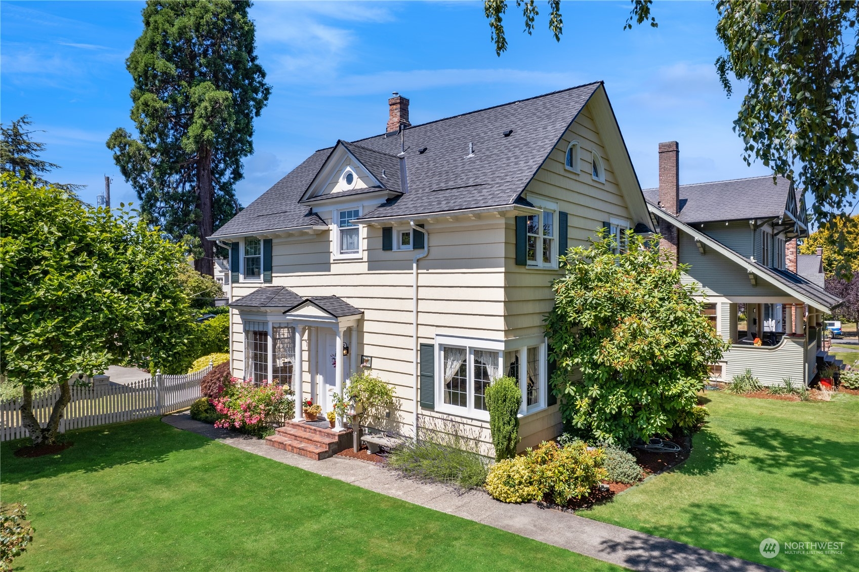 1812 Rucker Avenue Everett, WA 98201 - Photo 1 of 36 a front view of a house with a garden and plants