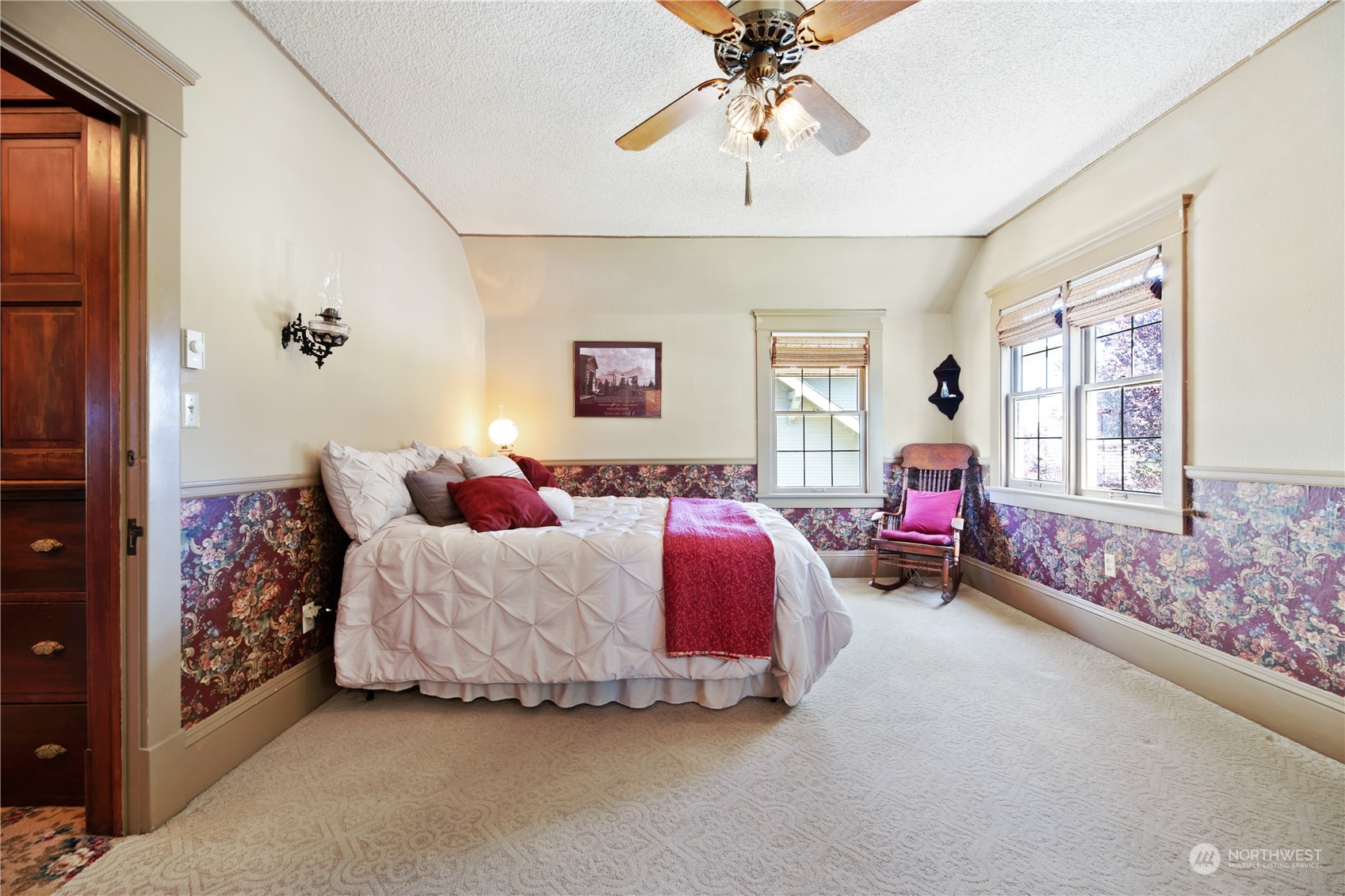 1812 Rucker Avenue Everett, WA 98201 - Photo 18 of 36 a bed room with a bed mirror and a chandelier