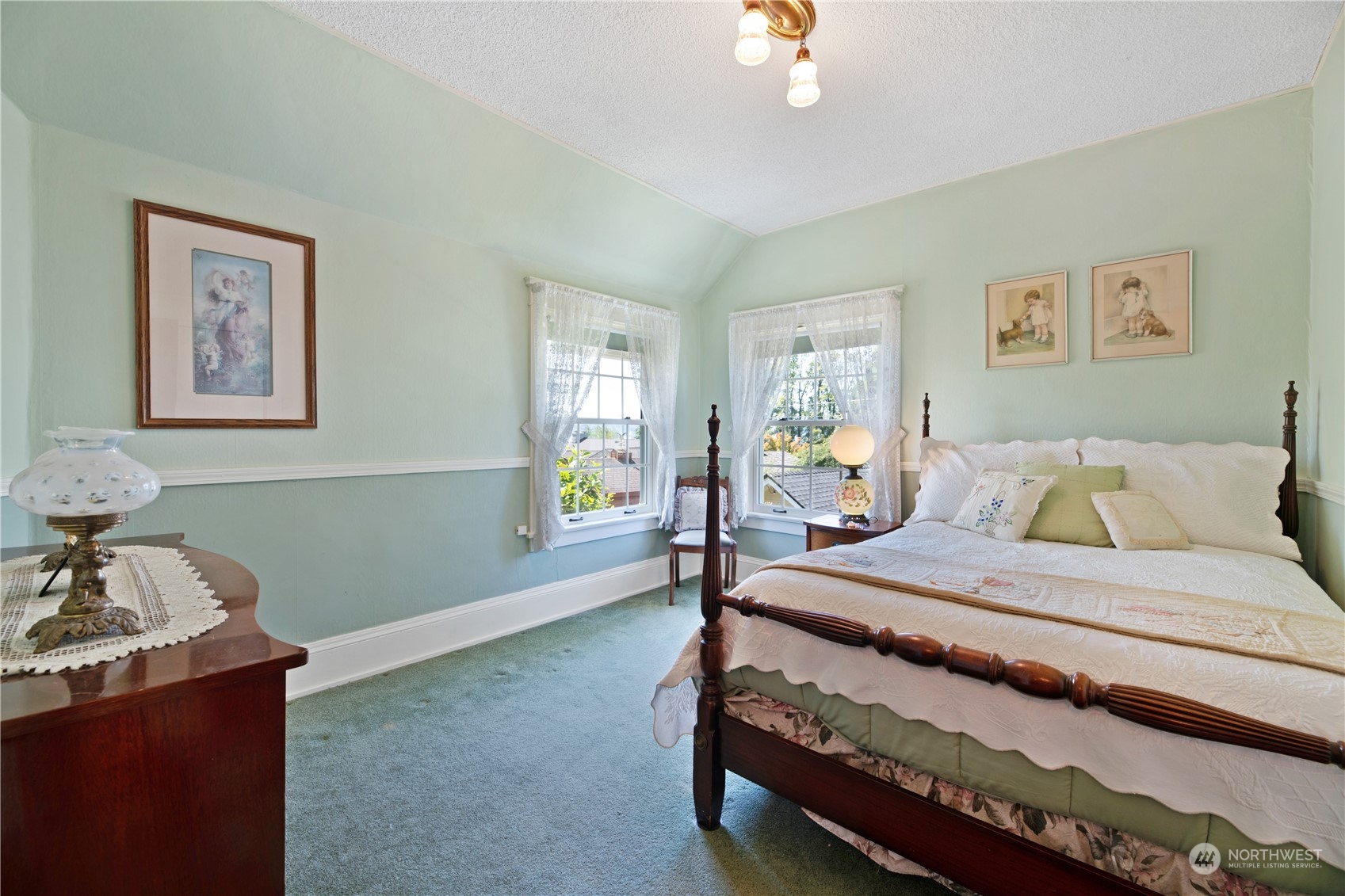 1812 Rucker Avenue Everett, WA 98201 - Photo 21 of 36 a bedroom with a bed and a chandelier