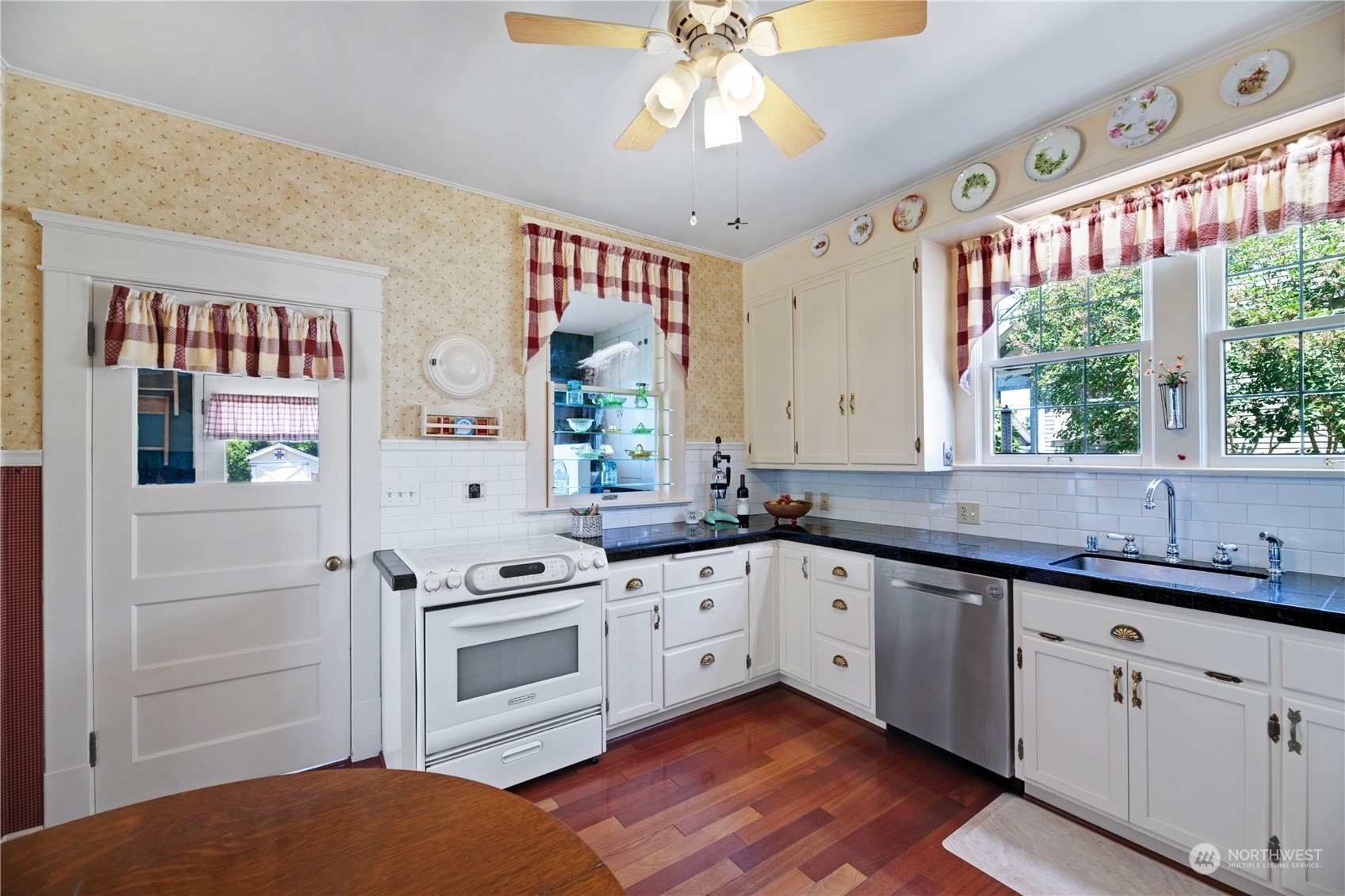 1812 Rucker Avenue Everett, WA 98201 - Photo 9 of 36 a kitchen with granite countertop a sink stainless steel appliances and cabinets