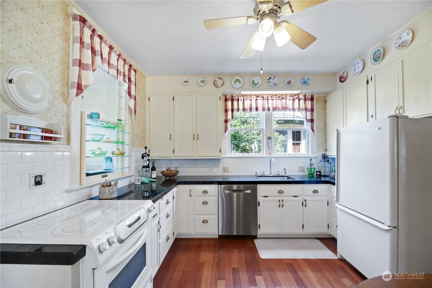 1812 Rucker Avenue Everett, WA 98201 - Photo 10 of 36 a kitchen with a sink window and cabinets