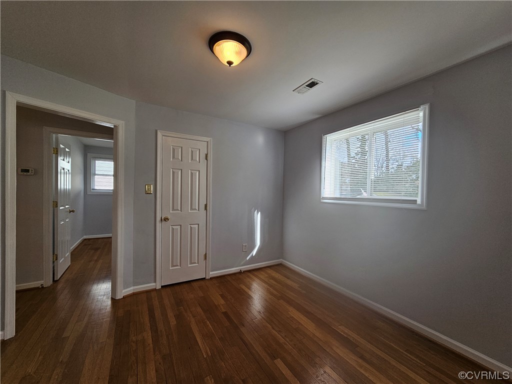3109 Putney Road Henrico, VA 23228 - Photo 11 of 27 an empty room with wooden floor and windows