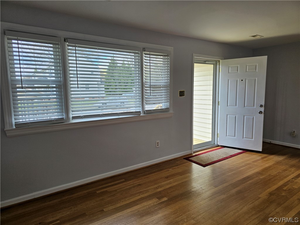 3109 Putney Road Henrico, VA 23228 - Photo 2 of 27 a view of an empty room with wooden floor and a window