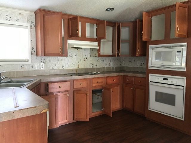 2589 Hortman Mill Road Roberta, GA 31078 - Photo 2 of 6 a kitchen with stainless steel appliances granite countertop a sink stove and cabinets