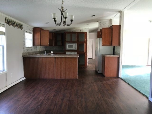 2589 Hortman Mill Road Roberta, GA 31078 - Photo 3 of 6 a kitchen with stainless steel appliances granite countertop a refrigerator a sink dishwasher a stove and a wooden floor