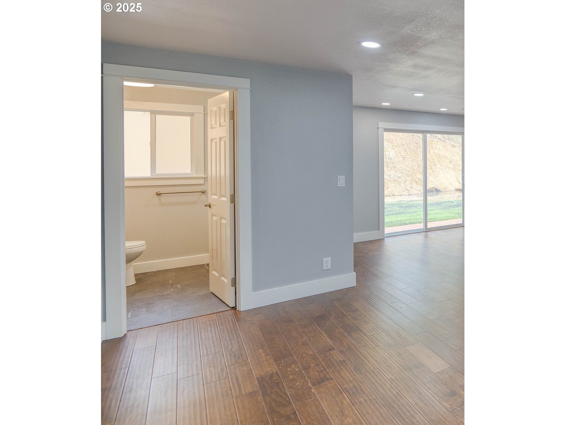 16855 Highway 42 Myrtle Point, OR 97458 - Photo 16 of 43 a view of an empty room with wooden floor and a window