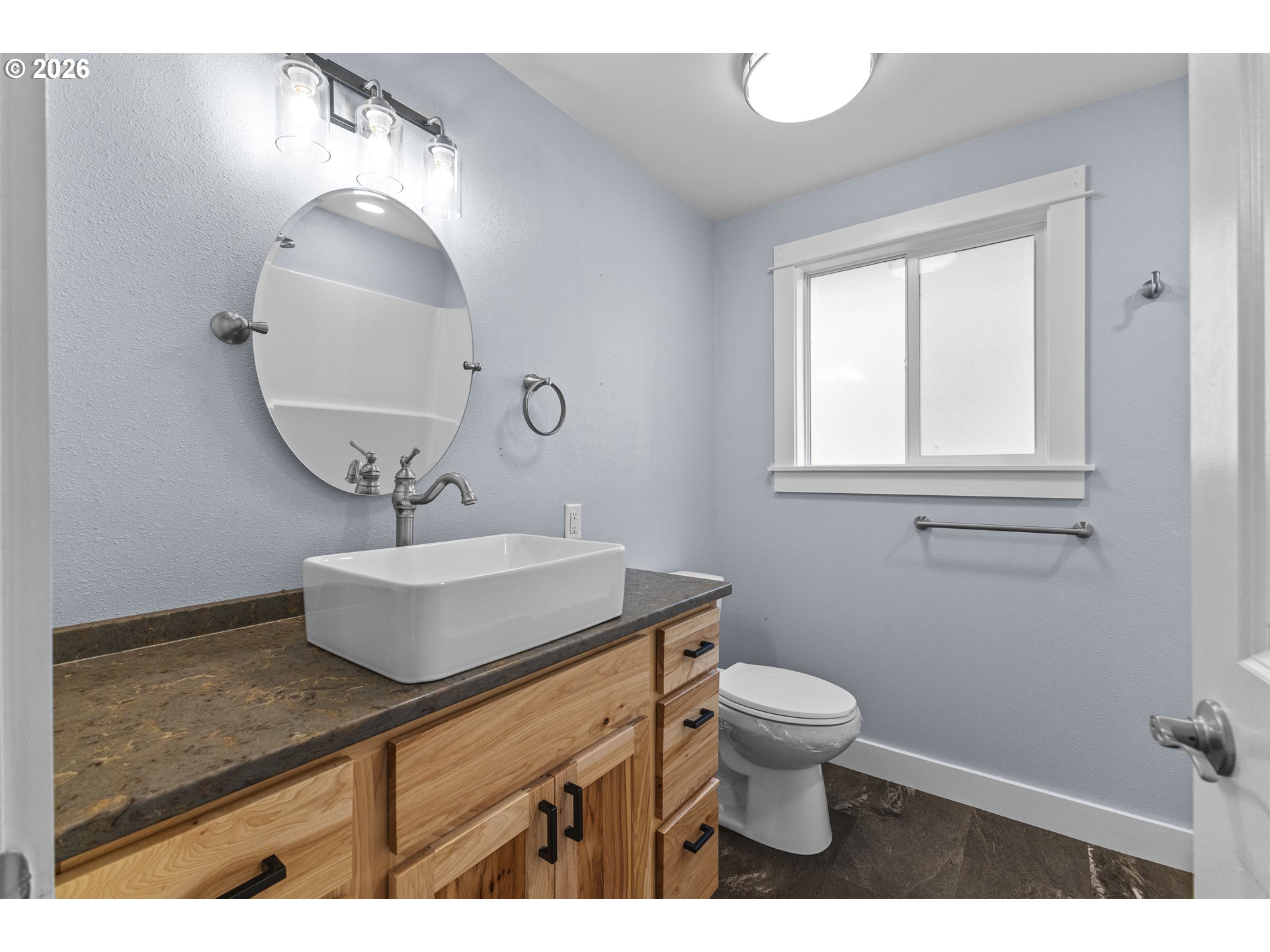 16855 Highway 42 Myrtle Point, OR 97458 - Photo 17 of 43 a bathroom with a toilet a sink and mirror