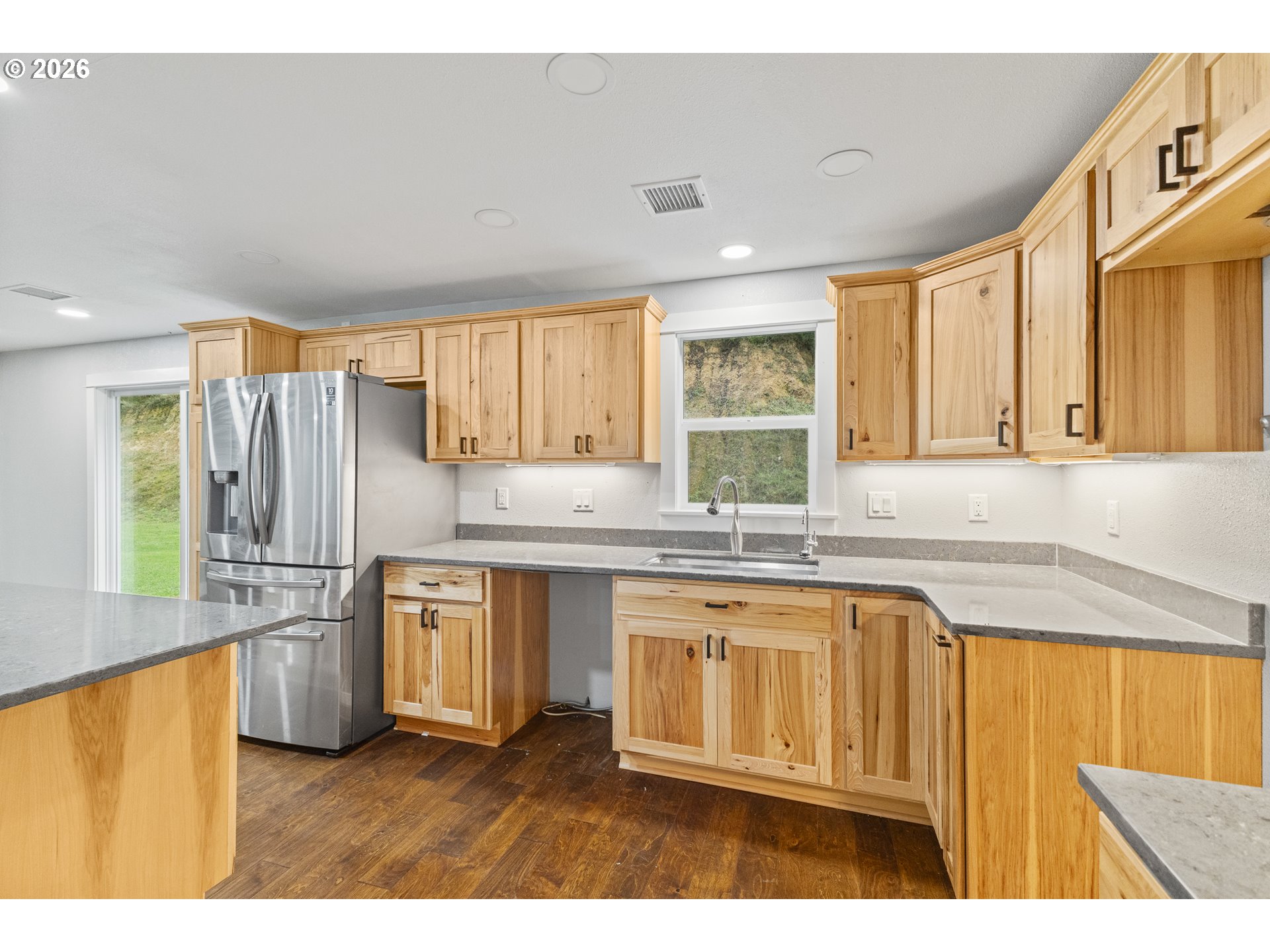 16855 Highway 42 Myrtle Point, OR 97458 - Photo 21 of 43 a kitchen with stainless steel appliances granite countertop a refrigerator a sink dishwasher a stove with wooden cabinets and floor