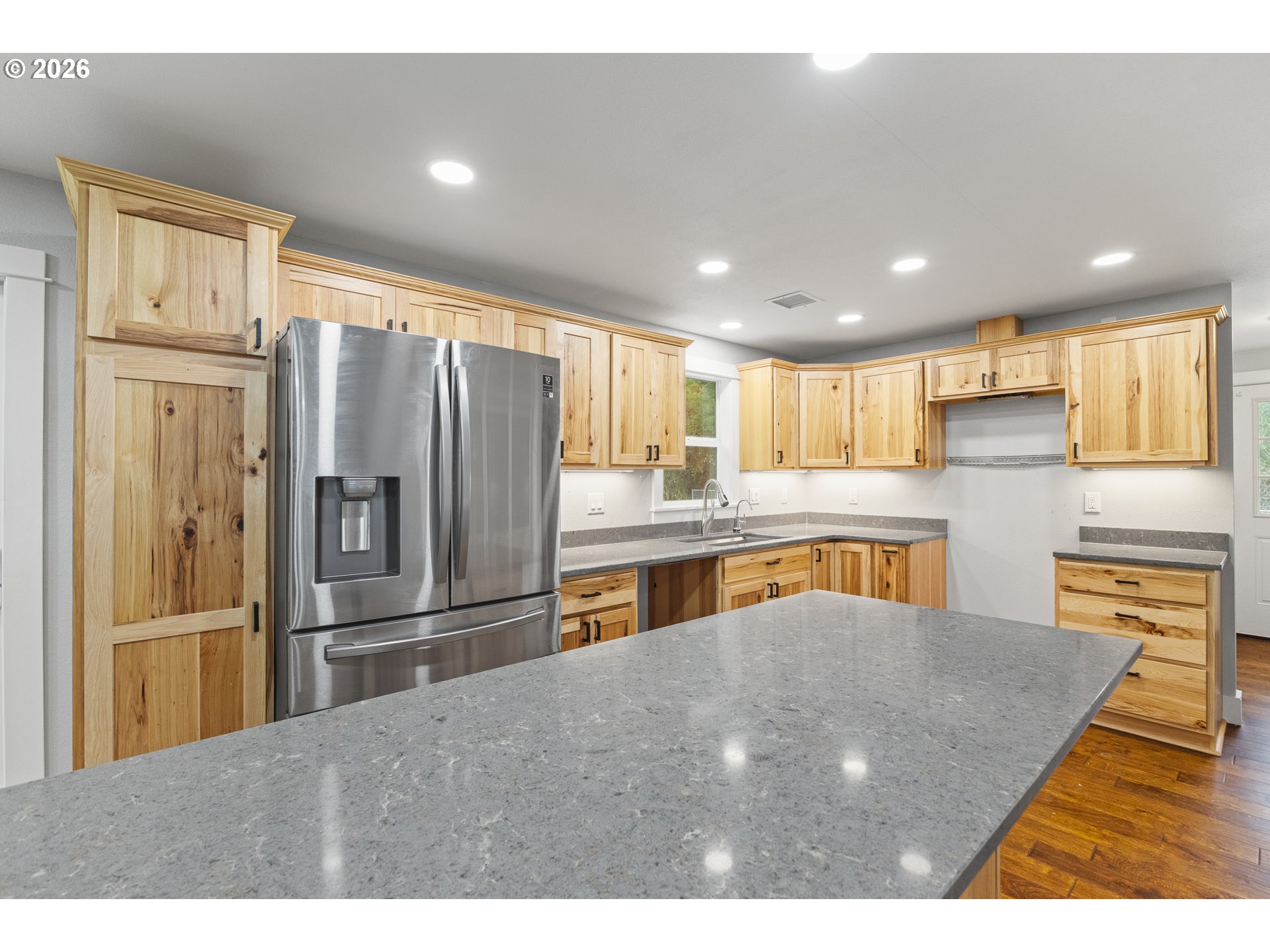 16855 Highway 42 Myrtle Point, OR 97458 - Photo 24 of 43 a kitchen with stainless steel appliances granite countertop a refrigerator a sink dishwasher a stove and a refrigerator with wooden floor