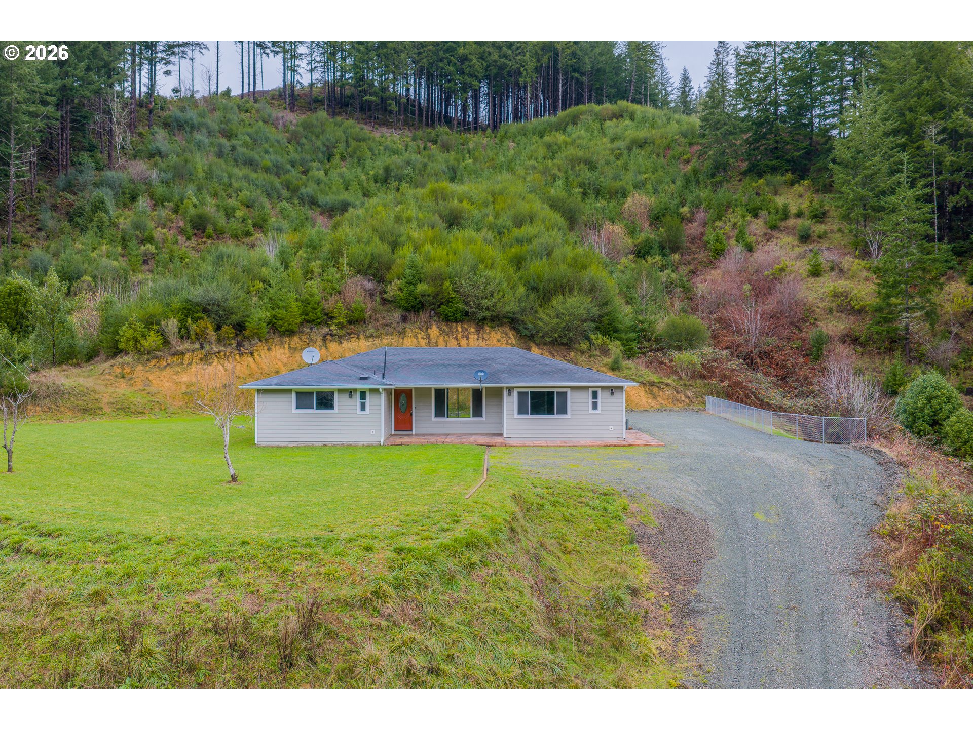 16855 Highway 42 Myrtle Point, OR 97458 - Photo 36 of 43 a view of a big house with a big yard and large tree