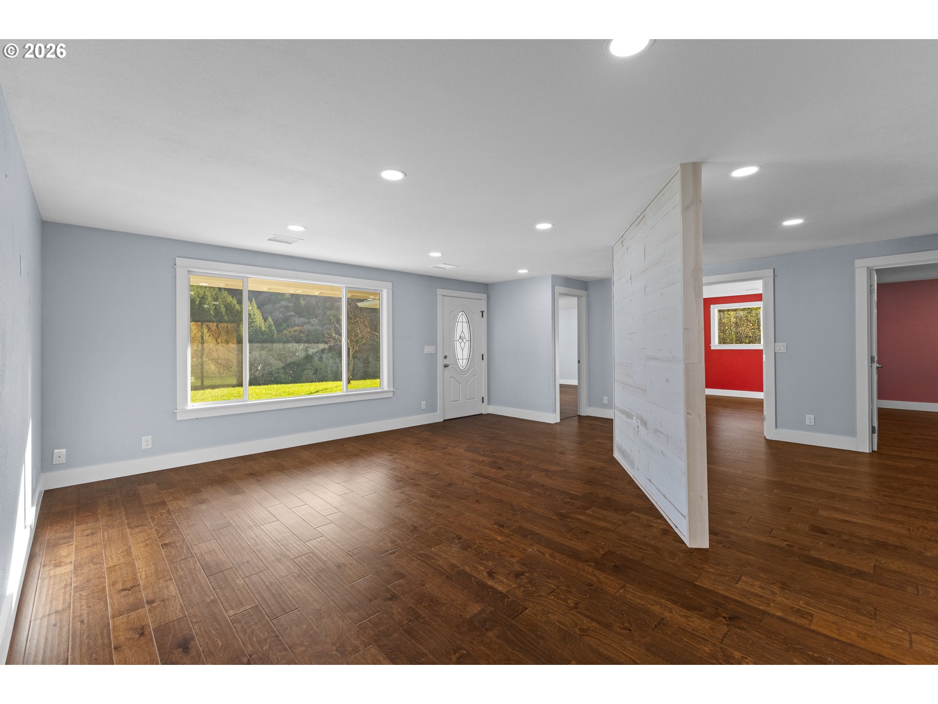 16855 Highway 42 Myrtle Point, OR 97458 - Photo 6 of 43 a view of an empty room with wooden floor and windows