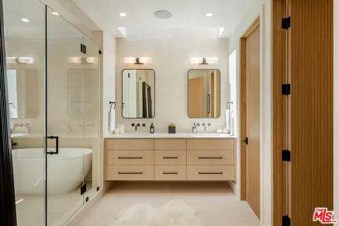 a bathroom with a double vanity sink mirror double and shower