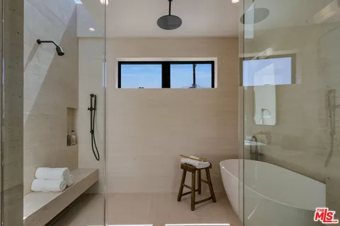 a bathroom with a tub and a shower
