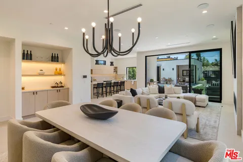 a living room with furniture a large window and gym equipment