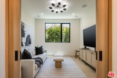 a living room with furniture and flat screen tv