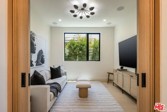 a living room with furniture and flat screen tv