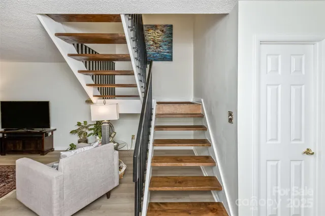 a view of a livingroom with furniture and stairs