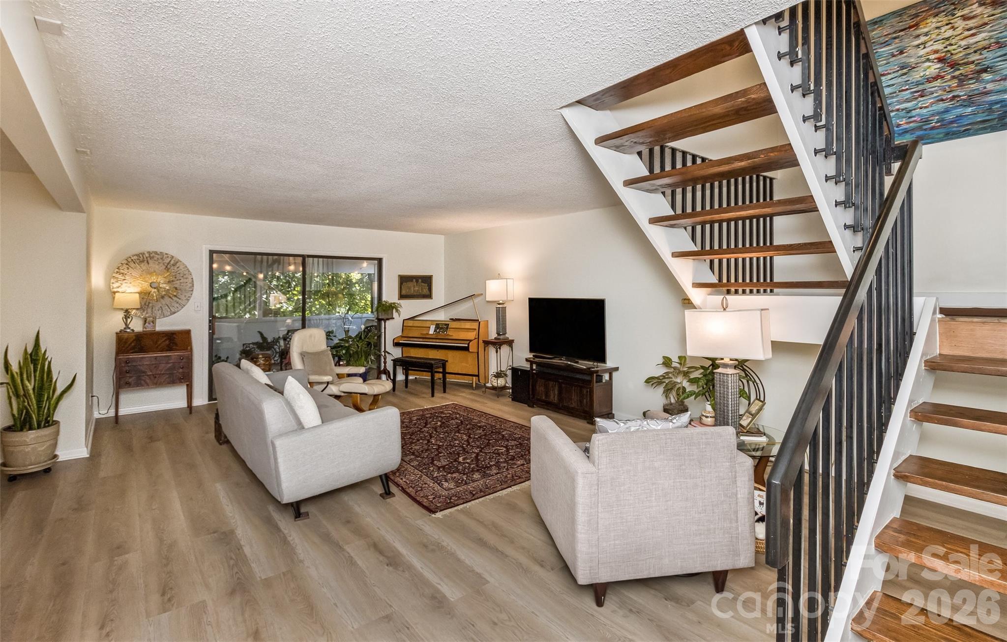 503 Crowfields Lane Asheville, NC 28803 - Photo 14 of 41 a living room with furniture and a flat screen tv