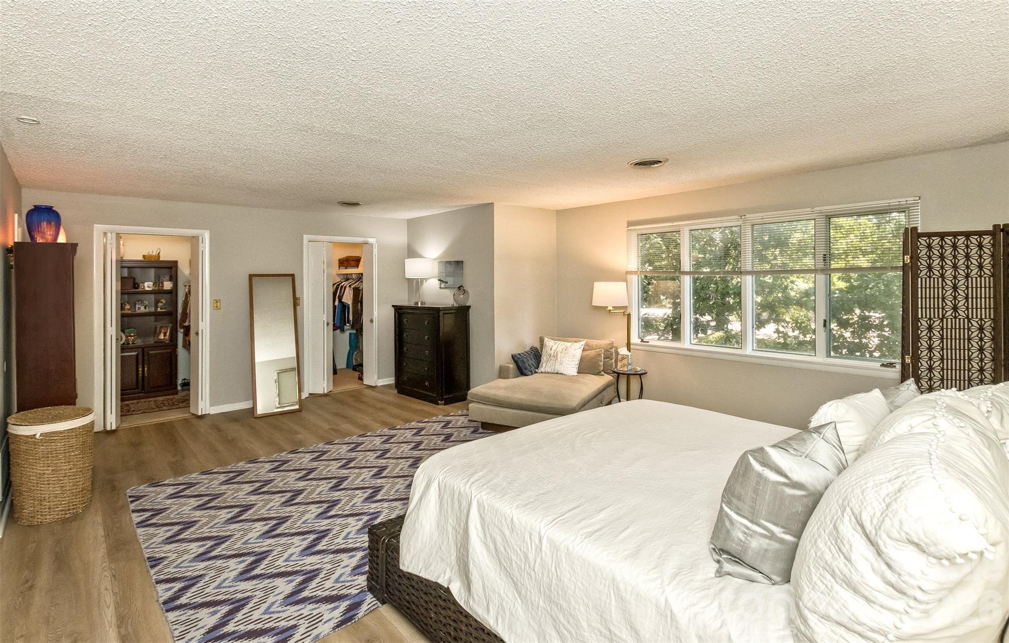 503 Crowfields Lane Asheville, NC 28803 - Photo 18 of 41 a spacious bedroom with a bed and glass windows