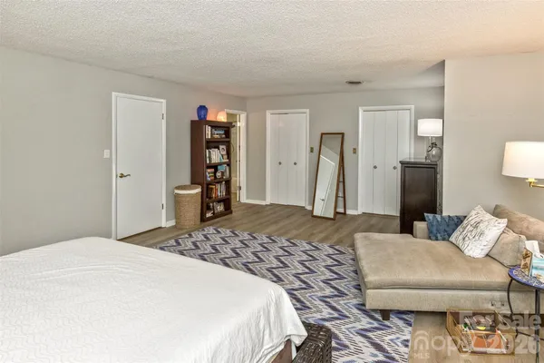 a bedroom with a bed and a couch