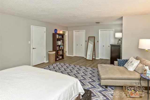 a bedroom with a bed and a couch