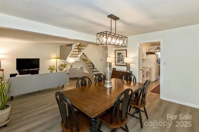 a view of a dining room with furniture wooden floor and chandelier