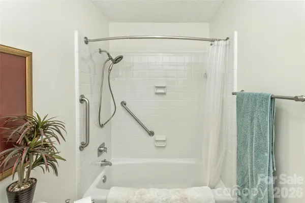 a bathroom with a shower a bath tub and a shower