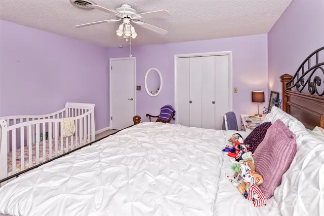 a bed room with a bed and a chandelier