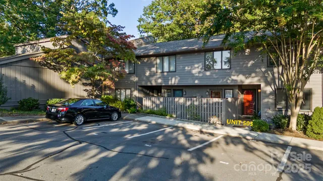 a view of a car park in front of a house
