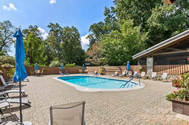 swimming pool view with a seating space