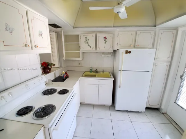 a kitchen with a refrigerator and a stove