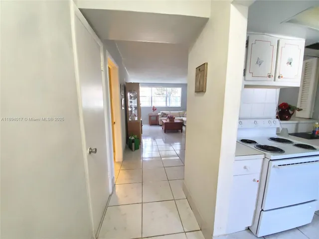 a view of a kitchen from the hallway