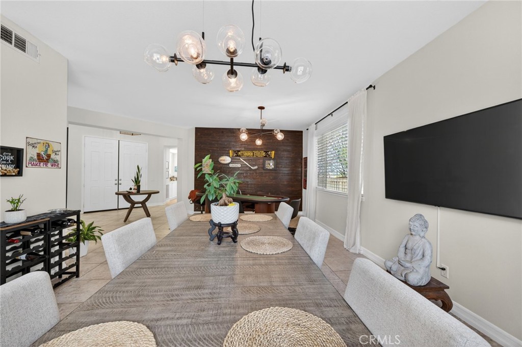 45136 Willowick Street Temecula, CA 92592 - Photo 12 of 75 a living room with furniture a chandelier and a flat screen tv