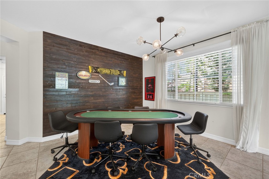 45136 Willowick Street Temecula, CA 92592 - Photo 15 of 75 a view of a dining room with furniture and a chandelier