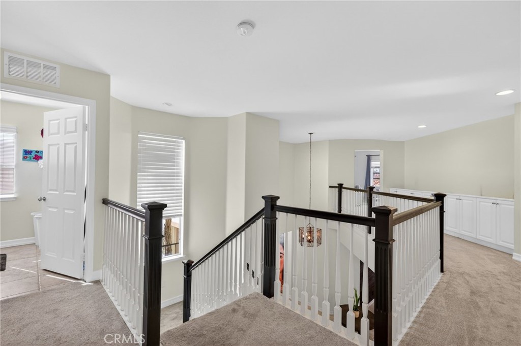 45136 Willowick Street Temecula, CA 92592 - Photo 23 of 75 a view of a hallway with windows