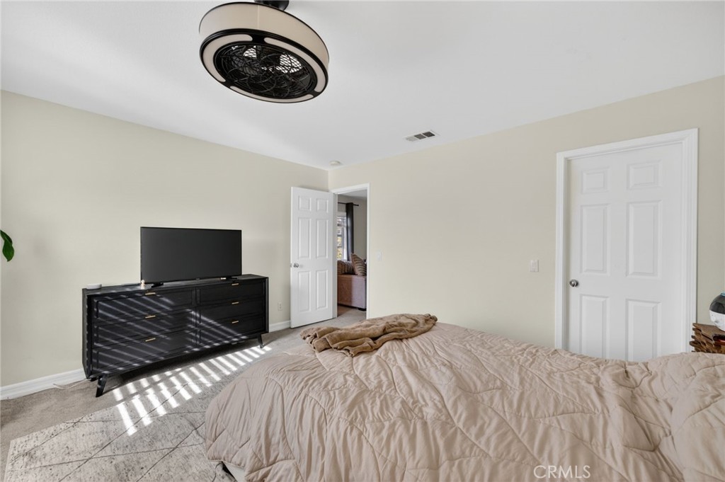 45136 Willowick Street Temecula, CA 92592 - Photo 29 of 75 a bedroom with a bed and a chair