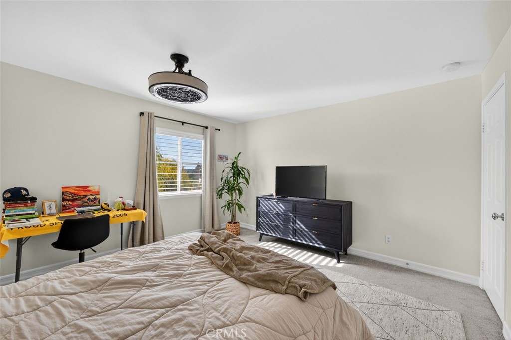 45136 Willowick Street Temecula, CA 92592 - Photo 30 of 75 a bedroom with a bed and wooden floor