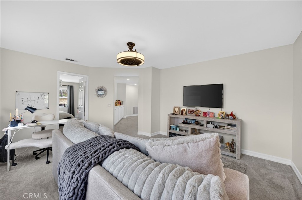45136 Willowick Street Temecula, CA 92592 - Photo 31 of 75 a bedroom with a bed and a flat screen tv