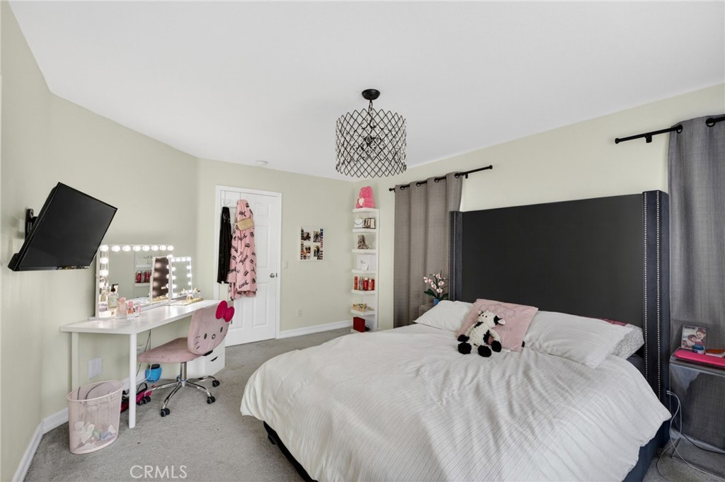 45136 Willowick Street Temecula, CA 92592 - Photo 34 of 75 a bedroom with a bed and a flat screen tv