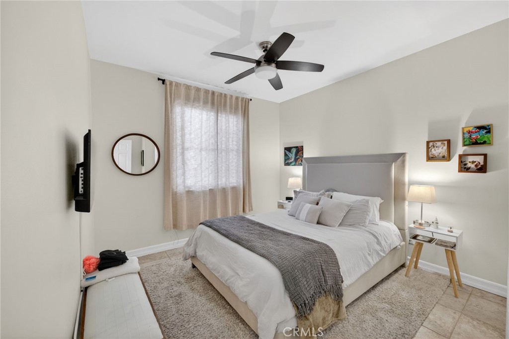 45136 Willowick Street Temecula, CA 92592 - Photo 36 of 75 a bedroom with a bed and a chandelier