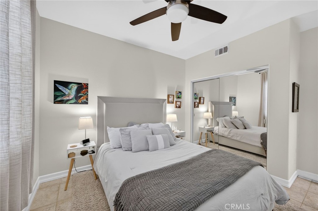 45136 Willowick Street Temecula, CA 92592 - Photo 37 of 75 a bedroom with a bed and a chandelier