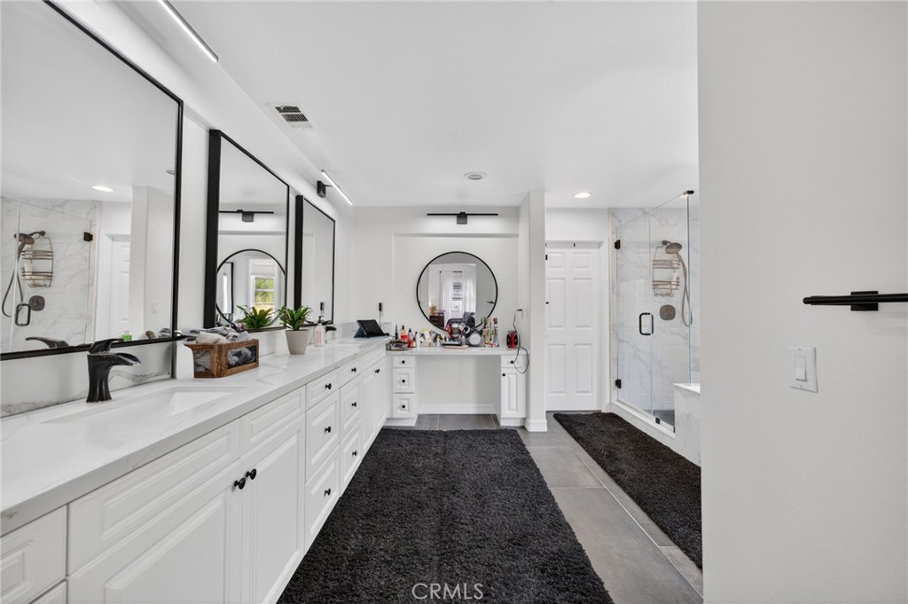 45136 Willowick Street Temecula, CA 92592 - Photo 46 of 75 a bathroom with double vanity and a bathtub