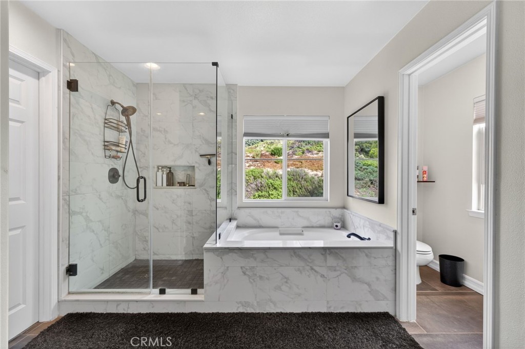 45136 Willowick Street Temecula, CA 92592 - Photo 47 of 75 a bathroom with a tub sink and shower